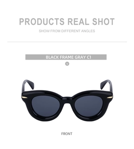 Vue frontale de lunettes de soleil œil-de-chat noires avec verres gris et détails dorés