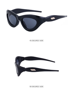 Detailed side view of black Y2K cat eye sunglasses with golden geometric metal accents