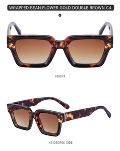 Macro detail of tortoiseshell square sunglasses with gold metal pins and gradient brown lenses