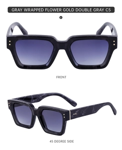 Detail view of square marble pattern sunglasses with blue gradient lenses and gold rivets
