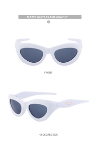 Detail view of matte white cat eye sunglasses with grey lenses and gold metal accents
