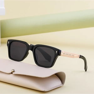 Detail of polarized sunglasses with gold textured metal temples and leather case