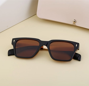 Close-up of polarized sunglasses showing the metal arrow decoration and specification code