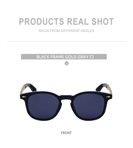 Front view of black square frame sunglasses with golden metal temples and gray lenses