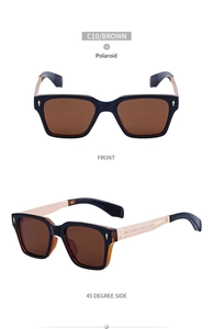 Close-up of polarized brown lenses and champagne gold engraved metal temples on sunglasses