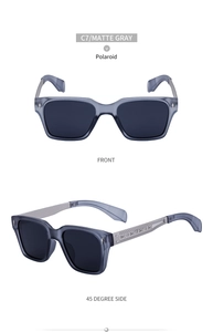 Detail of matte gray square frame sunglasses featuring intricate engraved metal temples