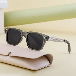 Polarized square sunglasses in translucent grey with silver metal accents and leather pouch