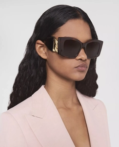 Detail of tortoiseshell cat-eye sunglasses with luxury gold V-logo on the temple