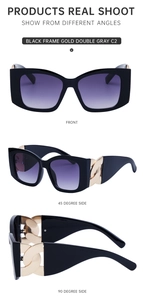 Detail of oversized cat-eye sunglasses with gold chain link decor and gradient lenses