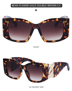 Detail view of tortoise shell sunglasses with gold chain accents and brown lenses