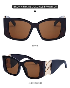 Detail of dark brown cat-eye sunglasses with golden chain metal hinge decoration