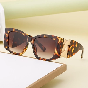 Fashionable tortoise shell square sunglasses with chunky gold chain detail on the temple