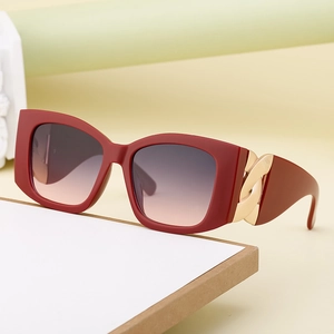 Fashionable oversized cat-eye sunglasses in wine red matte with gold chain link temple detail