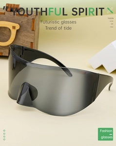 Close-up of futuristic sports sunglasses with large grey lenses and curved frame