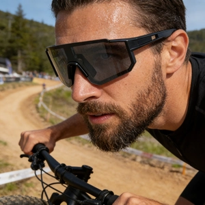 Close-up of polarized sports sunglasses on a model face showing windproof matte frame
