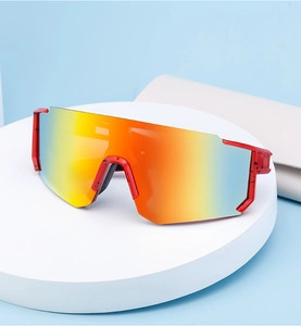 Detail view of polarized sports sunglasses with colorful gradient lenses and red frames