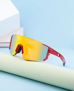 Macro view of polarized sports sunglasses with red ink-splash frame and orange mirror lens
