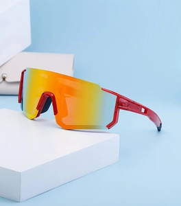 Detail of red polarized cycling sunglasses with orange mirrored lens and speckled frame