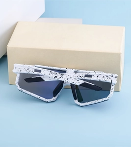 Close-up of white polarized sunglasses with black speckled texture on the large frame