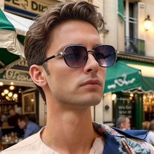 Male model wearing square black metal sunglasses with purple gradient lenses outdoors