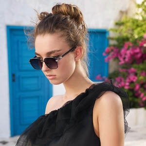 Men's square frame sunglasses with wood grain temples and gradient lenses on female model