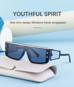 Detail of blue cyberpunk sunglasses with gold rivets and hollow geometric temples