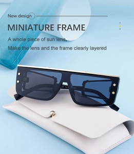 Detail of square oversized shield sunglasses with blue lenses and gold rivet accents