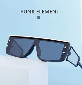 Detail of cyberpunk square sunglasses with gold metal top bar and punk rivets
