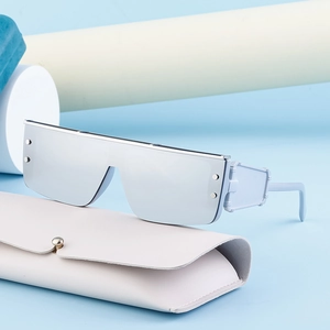 Cyberpunk light blue oversized sunglasses with silver mirrored lenses and rivets