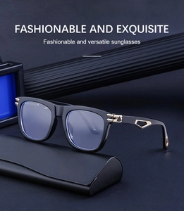 Detail of square black sunglasses with luxury gold hollow metal hinge on dark background