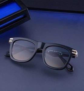 Detailed macro view of ZS98090 sunglasses featuring gold metal hinge and gradient lenses
