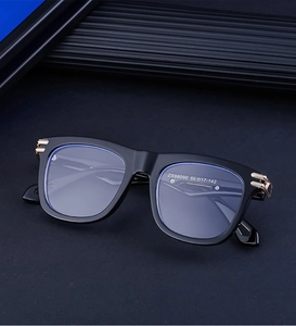 Macro detail of ZS98090 square sunglasses frame showing golden metal hinge accents
