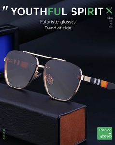 Detail of rimless square sunglasses with gold metal temples and striped pattern