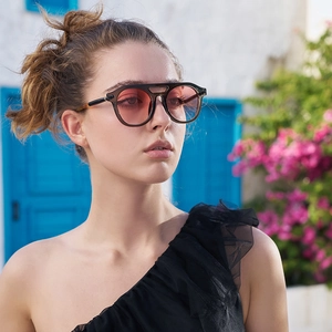 Steampunk sunglasses with brown circular frames and gradient lenses in outdoor setting