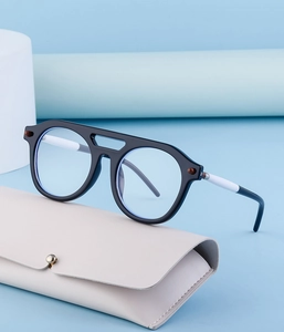 Steampunk sunglasses with matte black frame and cream leather case on blue background