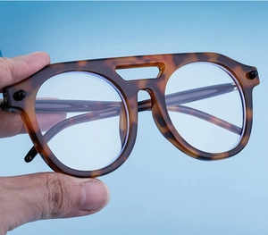 Detailed side view of tortoise shell steampunk sunglasses with double bridge frames
