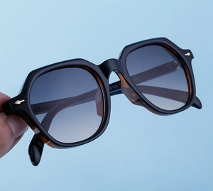 Macro detail of retro rectangular sunglasses with gold arrow hinges and gradient lenses