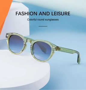 Close-up of retro oval sunglasses featuring light green frames and blue gradient lenses