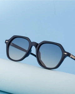 Macro shot of rectangular sunglasses with blue gradient lenses and gold metal accents