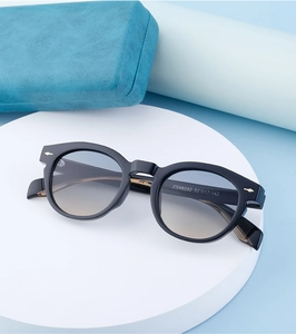 Detailed macro view of black oval sunglasses frames with ZS98092 model code on the temple