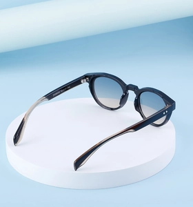Detail view of oval sunglasses with ZS98092 model specifications on the temple arm