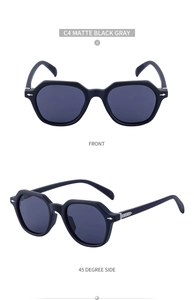 Detail view of matte black polygon sunglasses frames with silver rivets and grey lenses