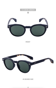 Detail view of oval retro sunglasses showing C5 demi green lenses and metal arrow accents