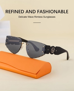 Detail of rimless wave-cut sunglasses with deer logo and orange leather case