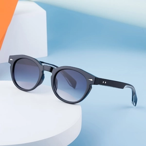 Vintage oval black sunglasses with blue gradient lenses and silver metal rivet accents