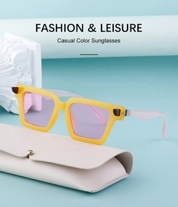 Detailed view of yellow square sunglasses with pink arms on a textured glasses case