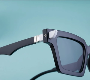 Detailed close-up of square sunglasses hinge with silver striped metal decor