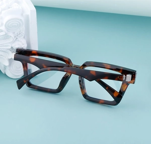 Close-up of retro square tortoise shell frame with silver metal hinge details