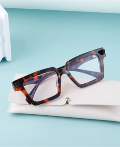Detail of vintage square tortoise frames with a white foldable leather spectacle case