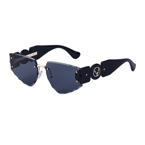 Fashion rimless sunglasses with carved grey lenses and thick temples featuring golden logo